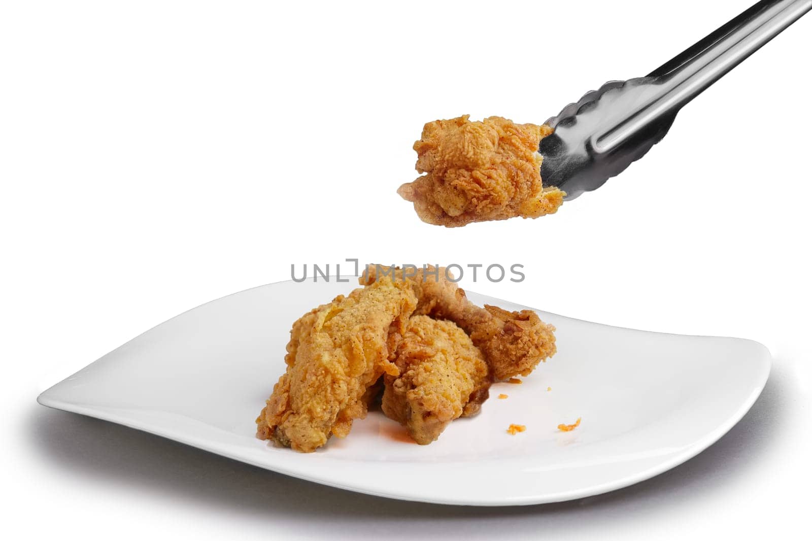 Crisp grilled chicken wings on a white dish