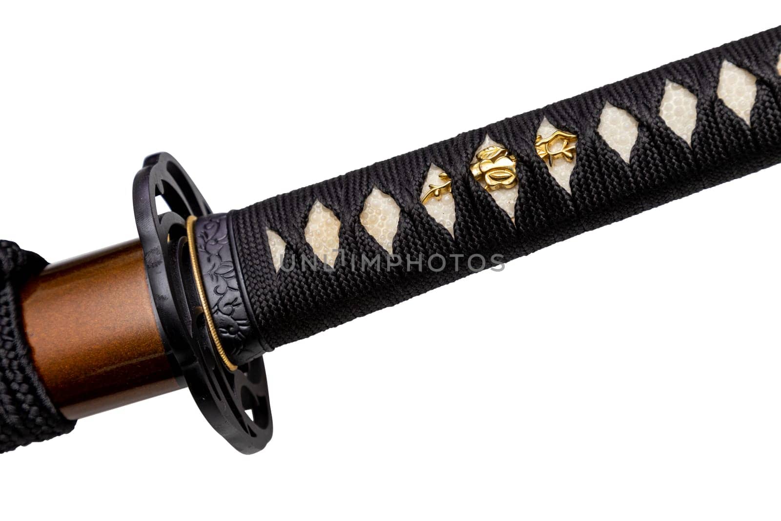 Tsuka - handle of Japanese sword wrapped by black silk cord on white ray skin isolated in white background. Selective focus.