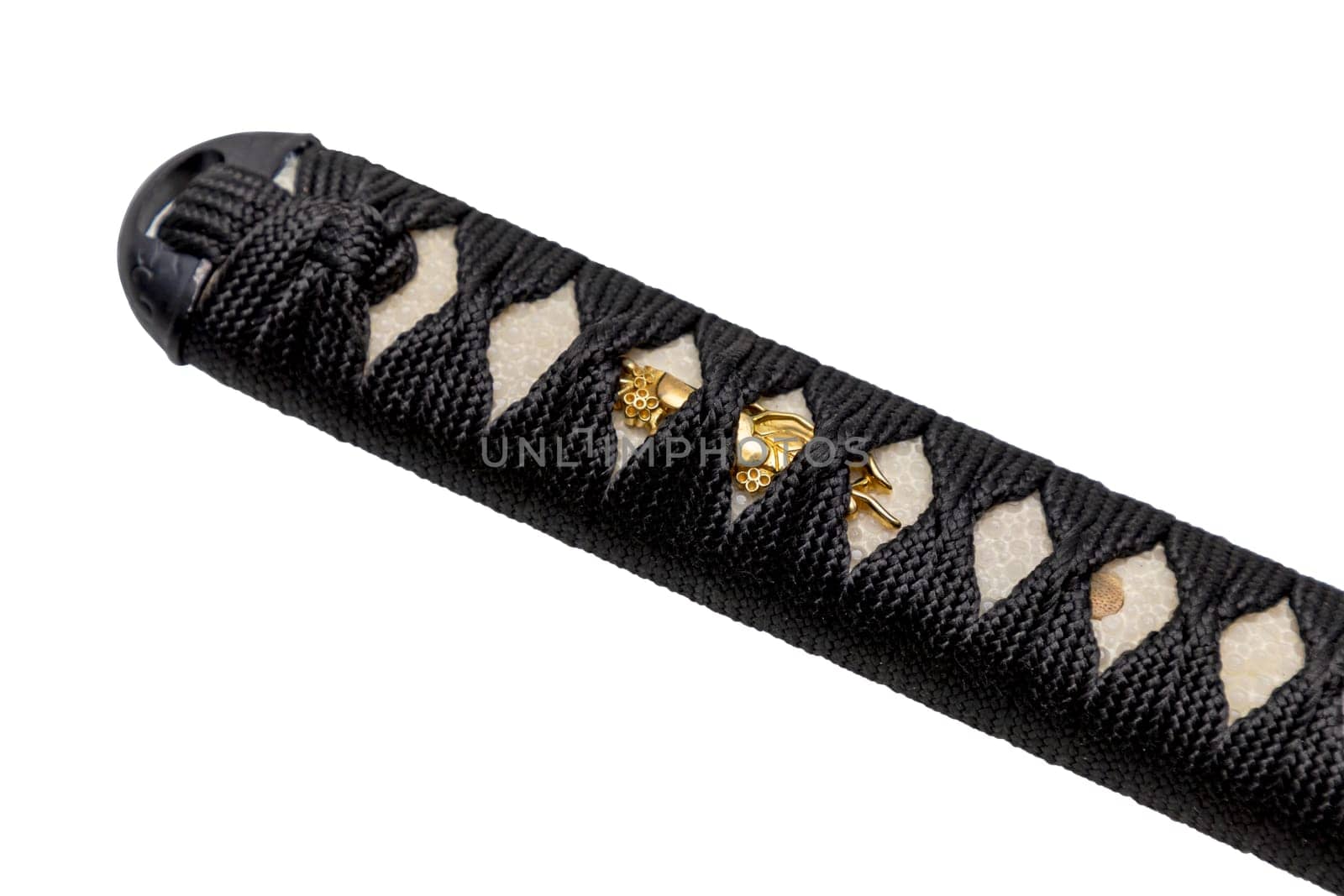 Tsuka - handle of Japanese sword wrapped by black silk cord on white ray skin isolated in white background. Selective focus.