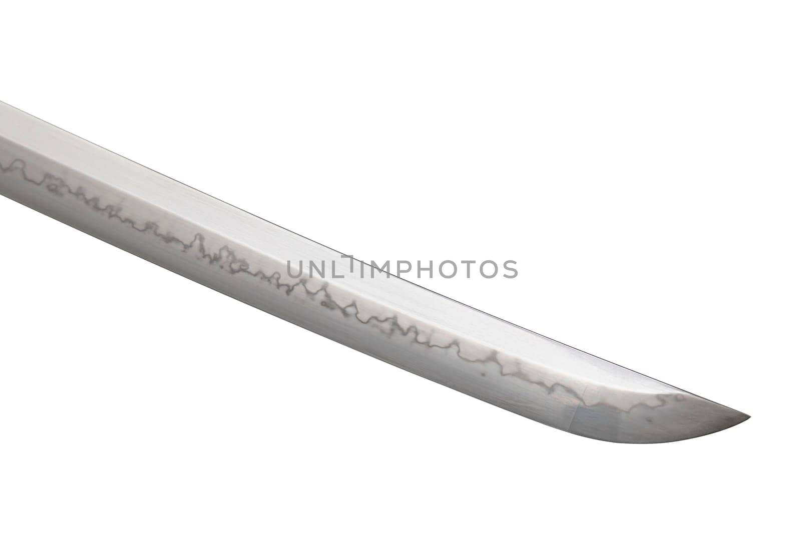 Japanese sword blade on white background. Soft focus. The wavy pattern on the blade edge is a line of hardness that a blacksmith makes so that the blade doesn't break. Choji Hamon style.