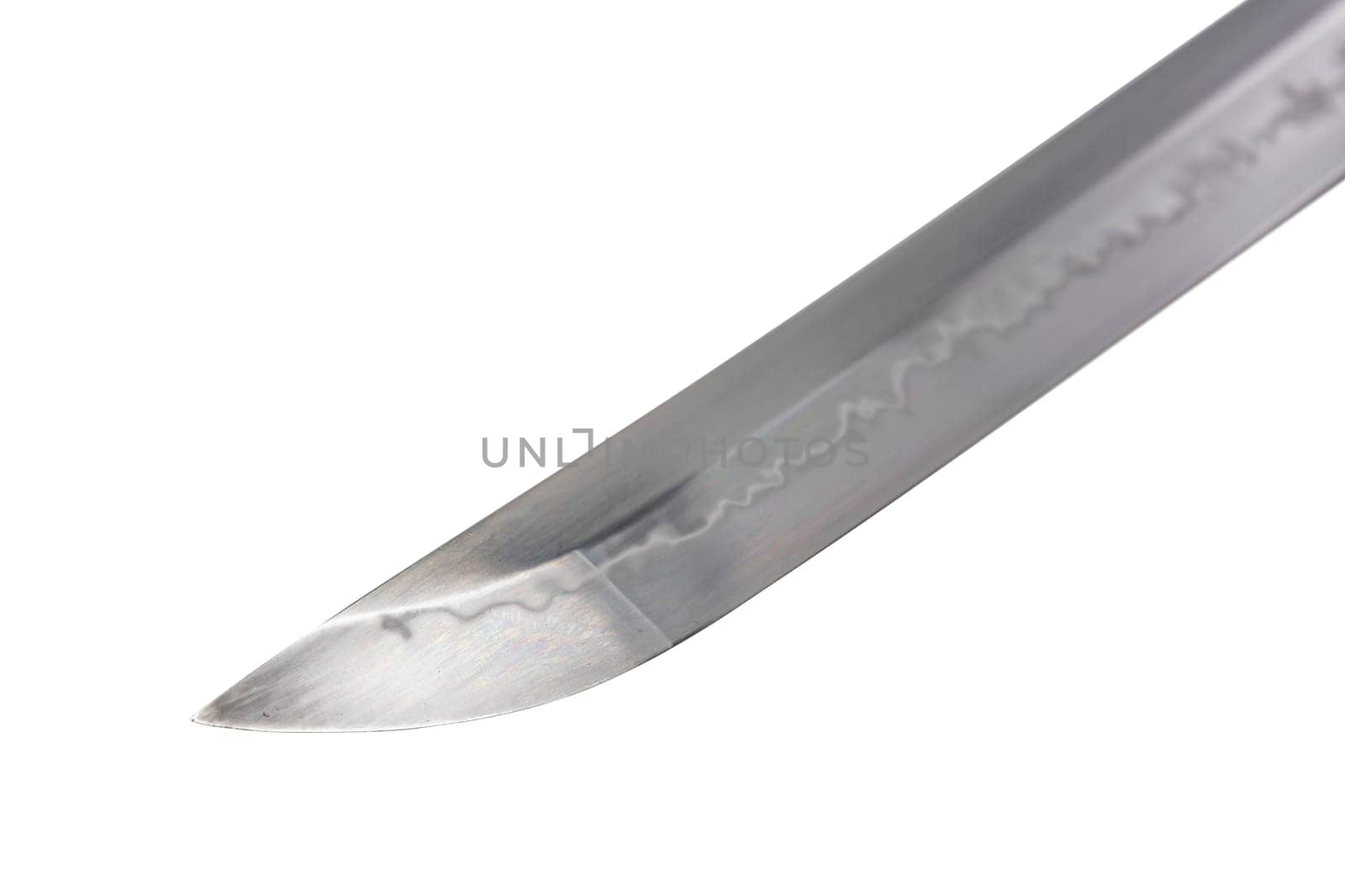 Japanese sword blade on white background. Soft focus. The wavy pattern on the blade edge is a line of hardness that a blacksmith makes so that the blade doesn't break. Choji Hamon style.