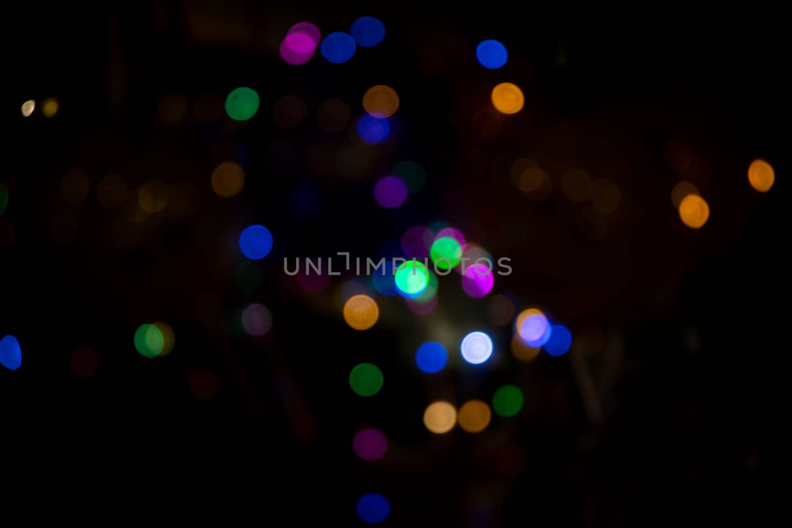 Abstract colorful bokeh light effects on the night black background texture