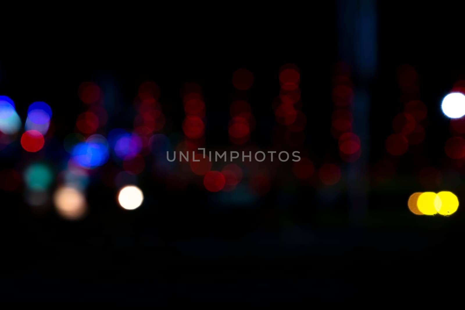 Abstract colorful bokeh light effects on the night black background texture