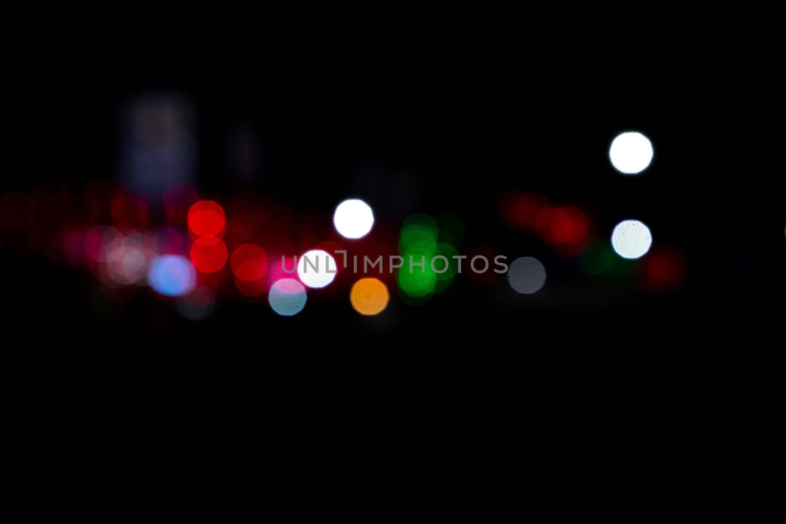 Abstract colorful bokeh light effects on the night black background texture