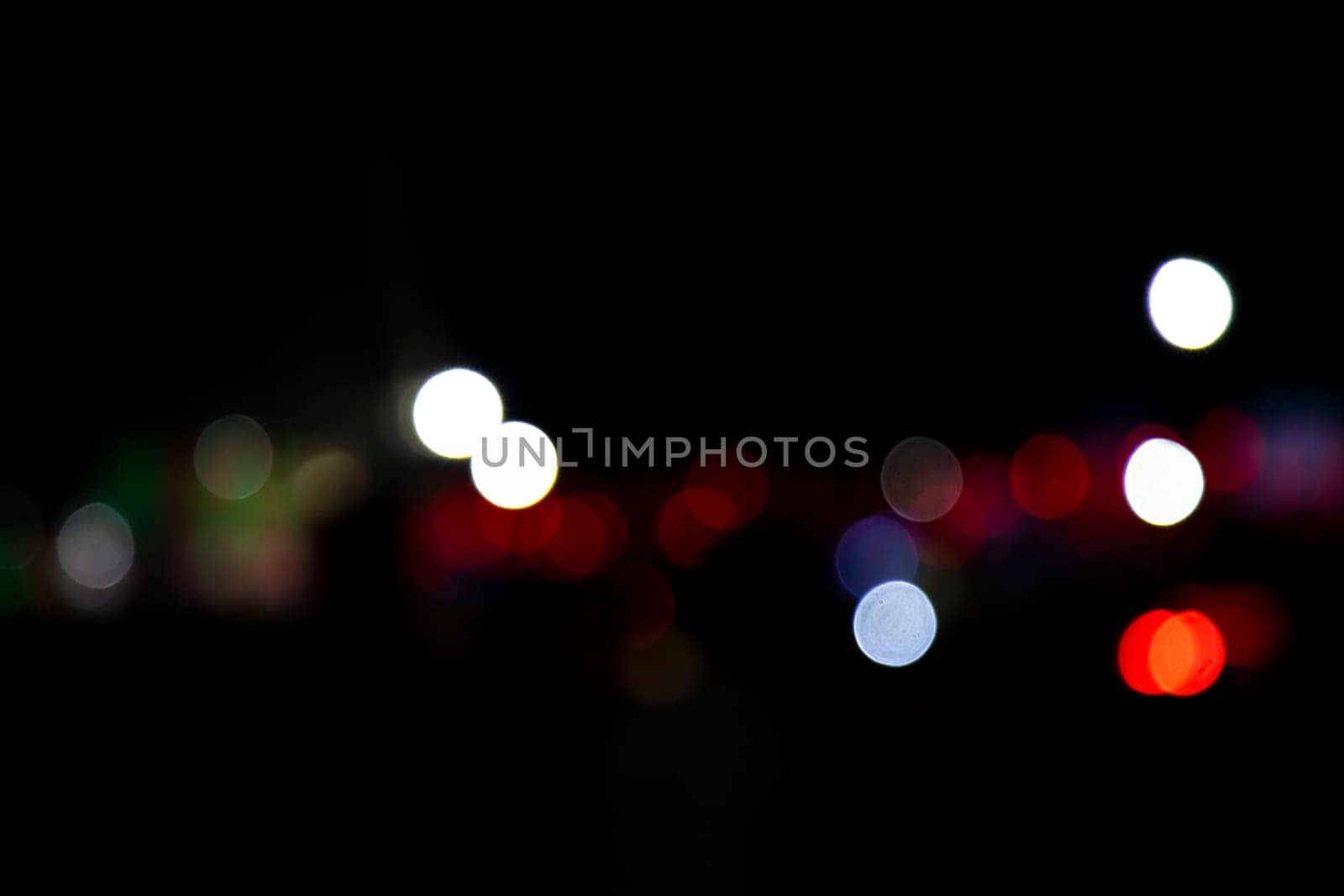 Abstract colorful bokeh light effects on the night black background texture