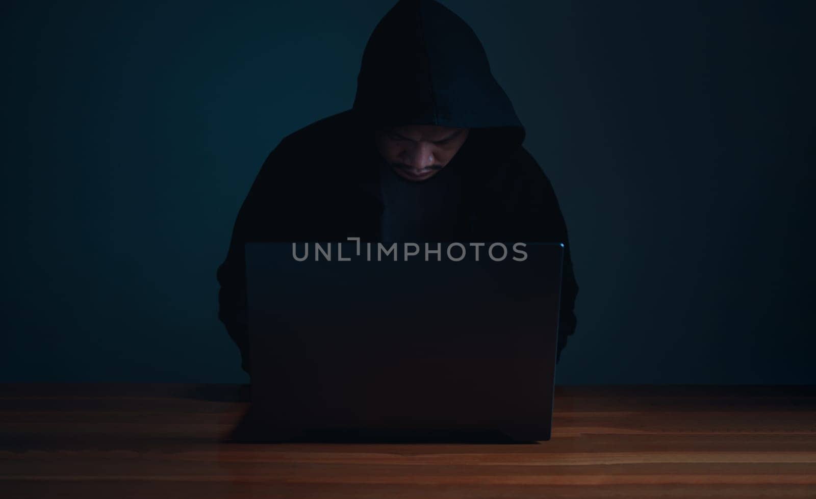 Hackers work on laptops in the dark. The concept of information security in the Internet network and information espionage.