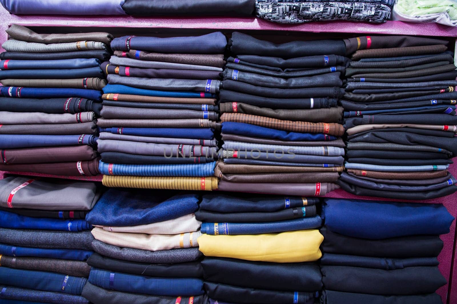 Patterned Textile Fabrics  stacked on a retail Shop Shelf for sale