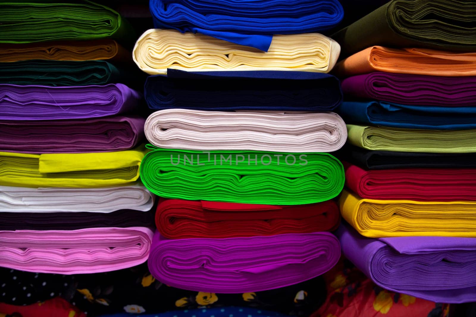 Artistic variety shade tone colors Textile Fabrics stacked on retail Shop Shelf to sale