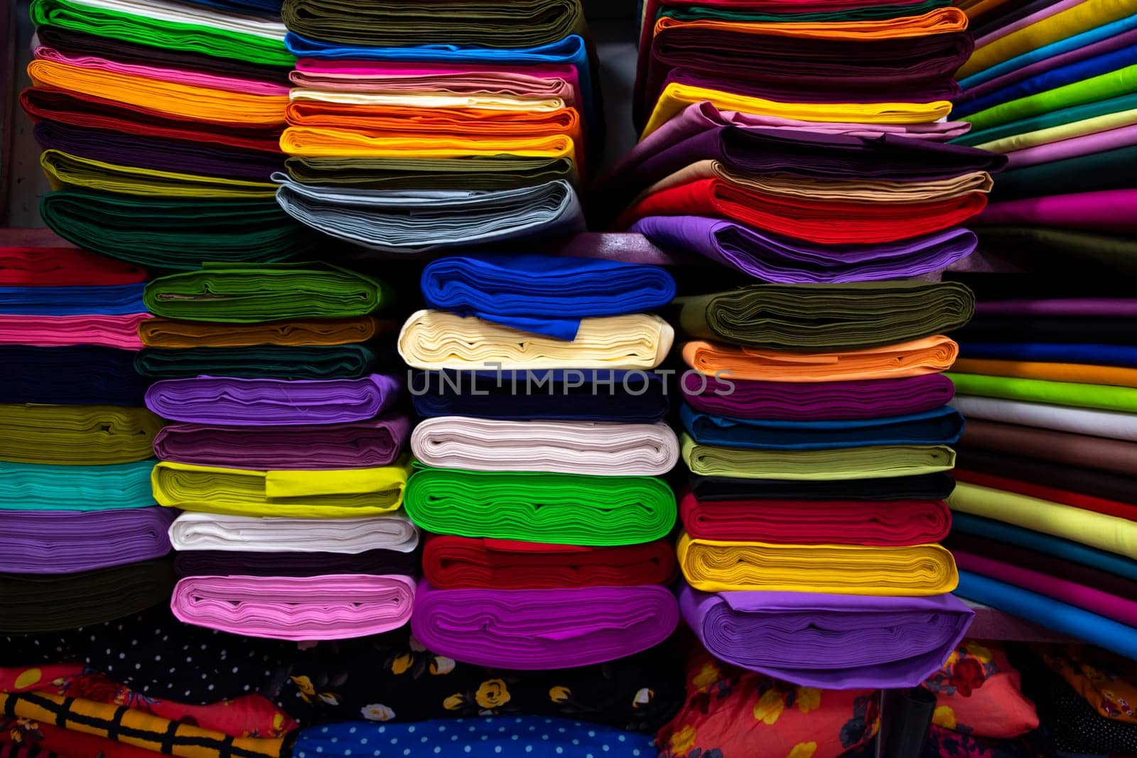 Artistic variety shade tone colors Textile Fabrics stacked on retail Shop Shelf to sale