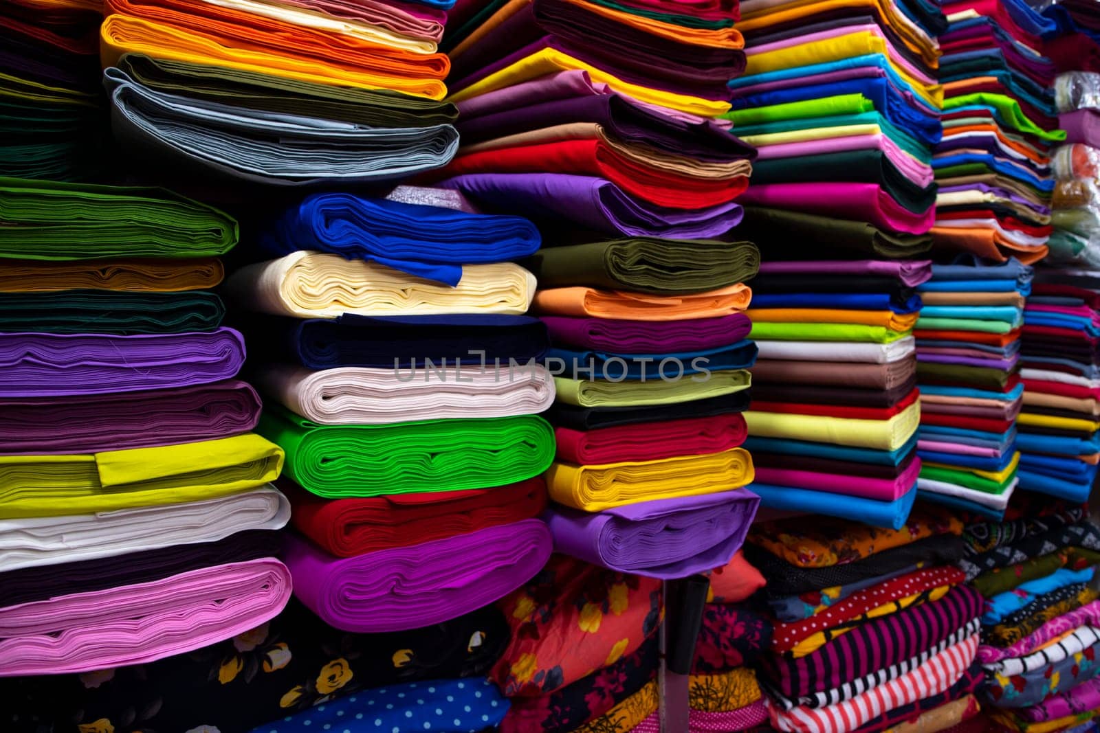 Artistic variety shade tone colors Textile Fabrics stacked on retail Shop Shelf to sale