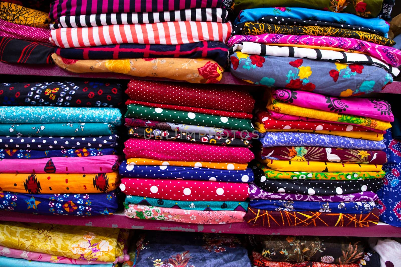 Artistic variety shade tone colors Textile Fabrics stacked on retail Shop Shelf to sale