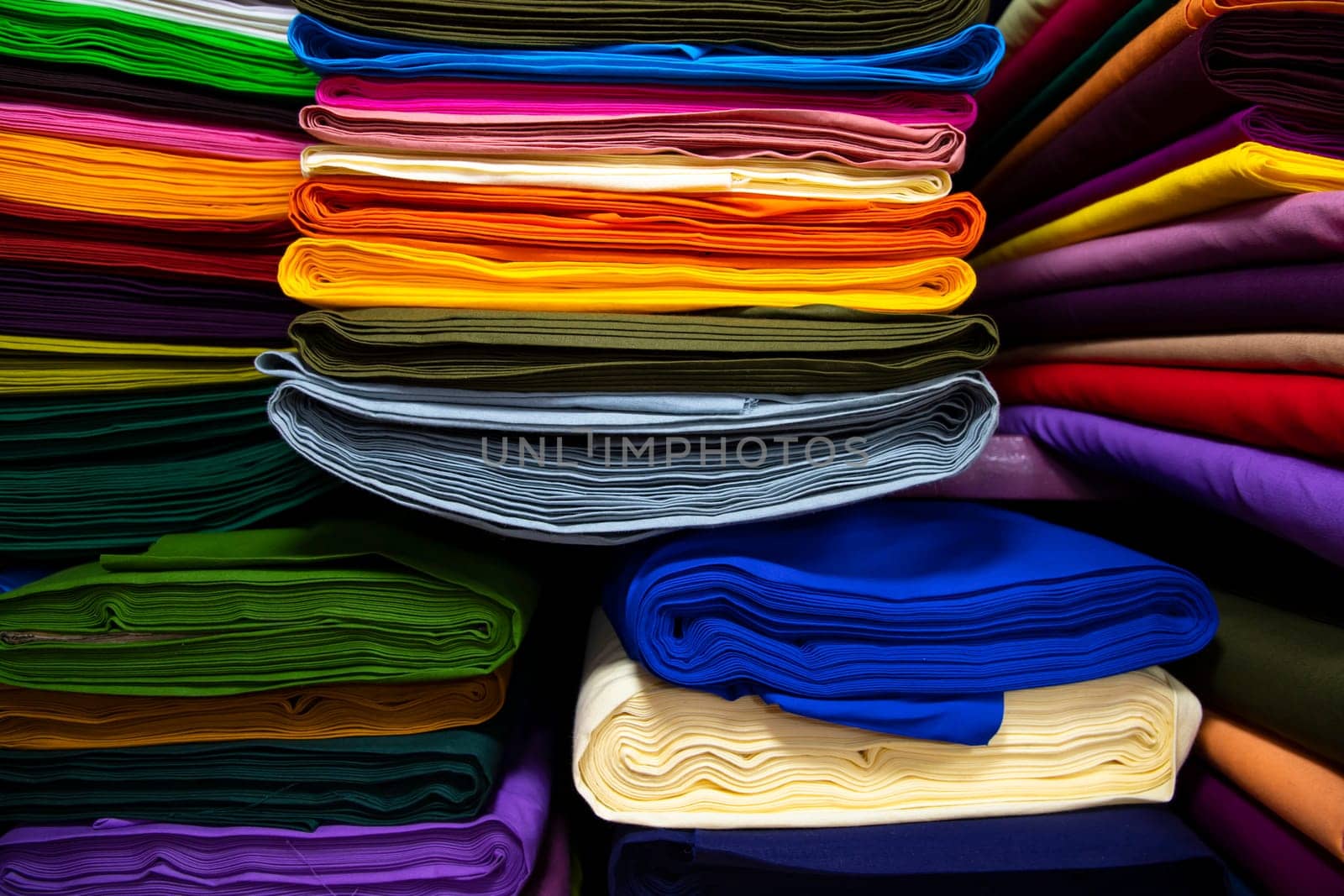 Artistic variety shade tone colors Textile Fabrics stacked on retail Shop Shelf to sale