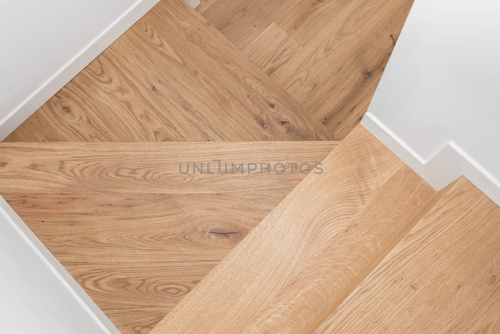 Modern residential wooden stairs. Wood staircase inside contemporary white modern house.