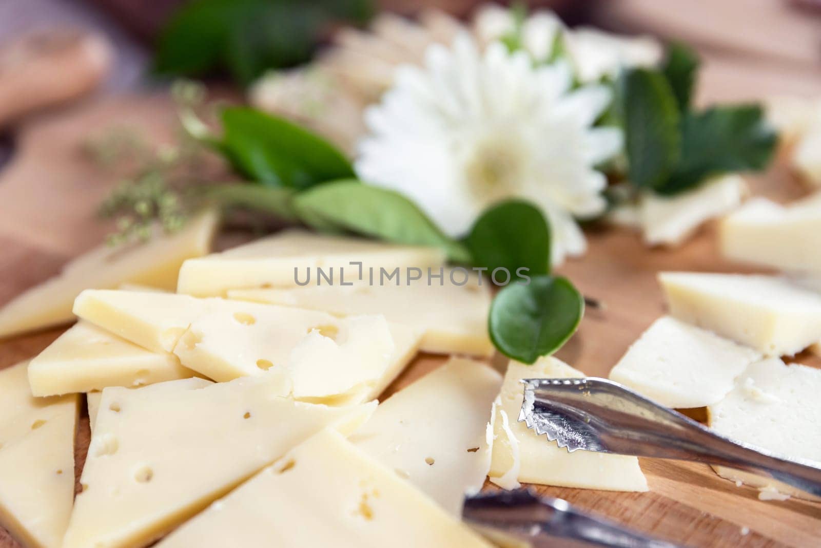 Cheese platter with different varieties, on wooden board. Selective focus.