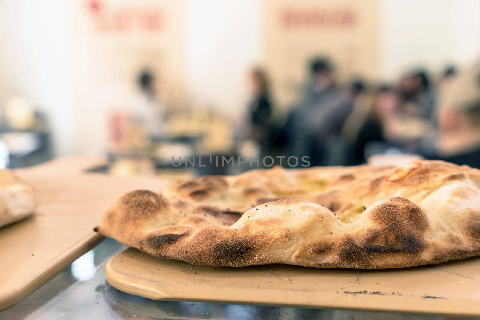 A beautiful traditional focaccia. Fresh bread. Focaccia on wooden cutting board.
