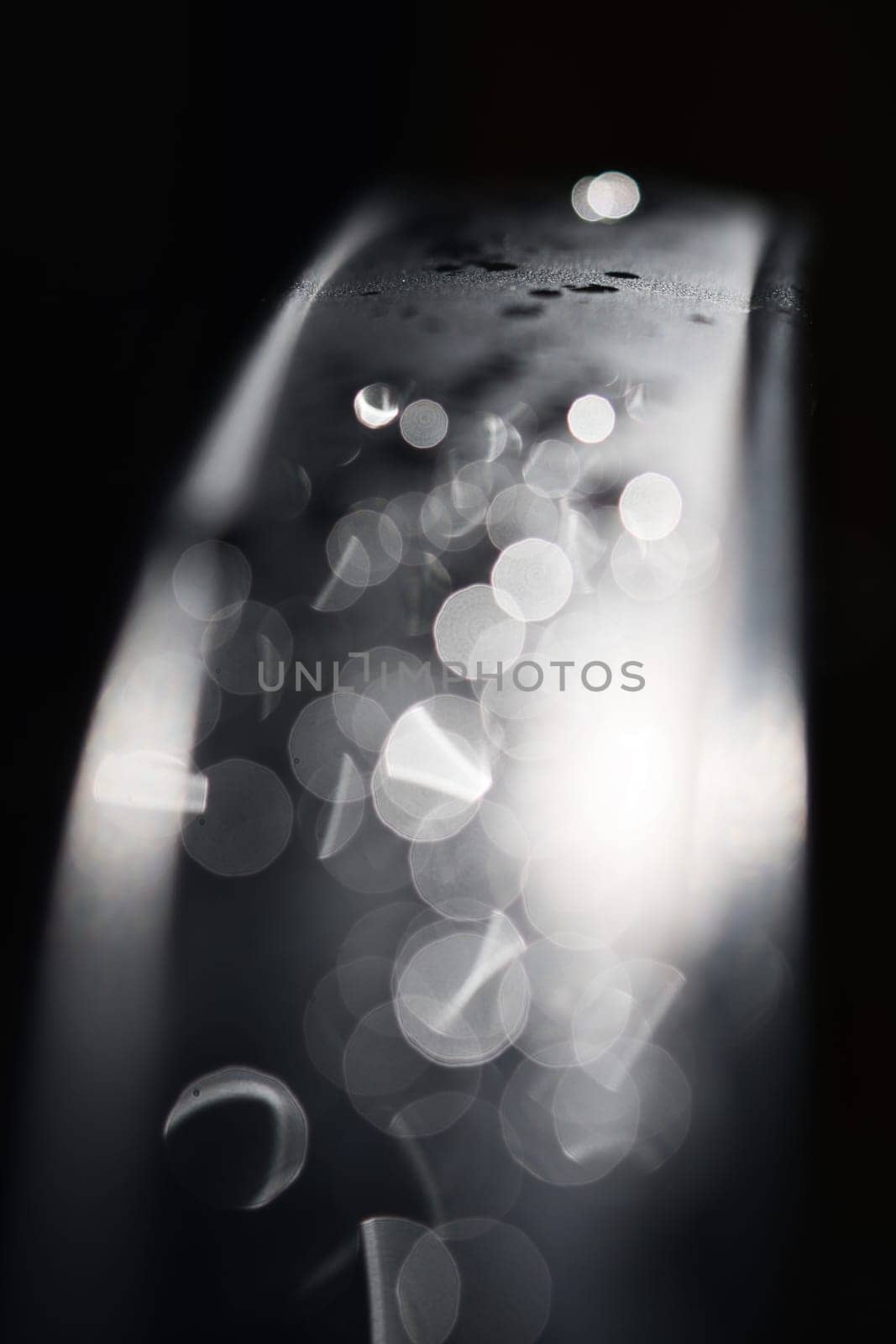 Water drops Abstract and with blurred background shines on a metal surface of a chair. Abstract macro shot