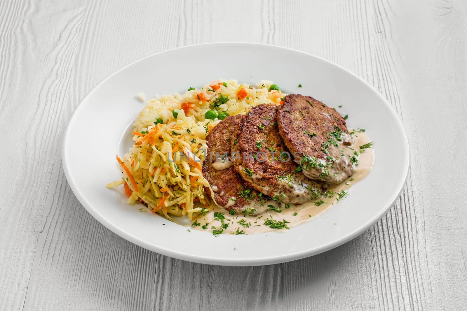 Plate with liver cutlet, rice with peas and pickled cabbage