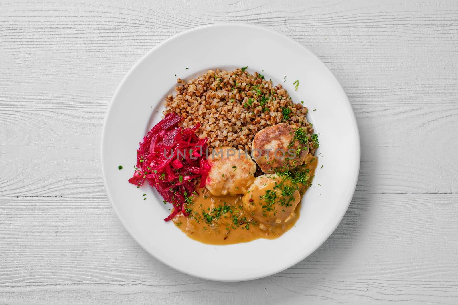 Top view of plate with meatballs, buckwheat and beetroot salad