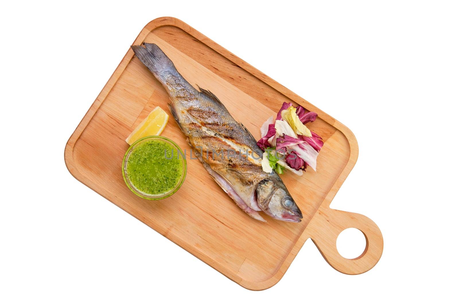 Whole fried fish on wooden board