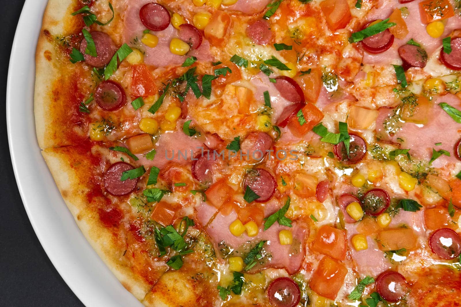 pizza with ham, smoked sausage, bacon and corn