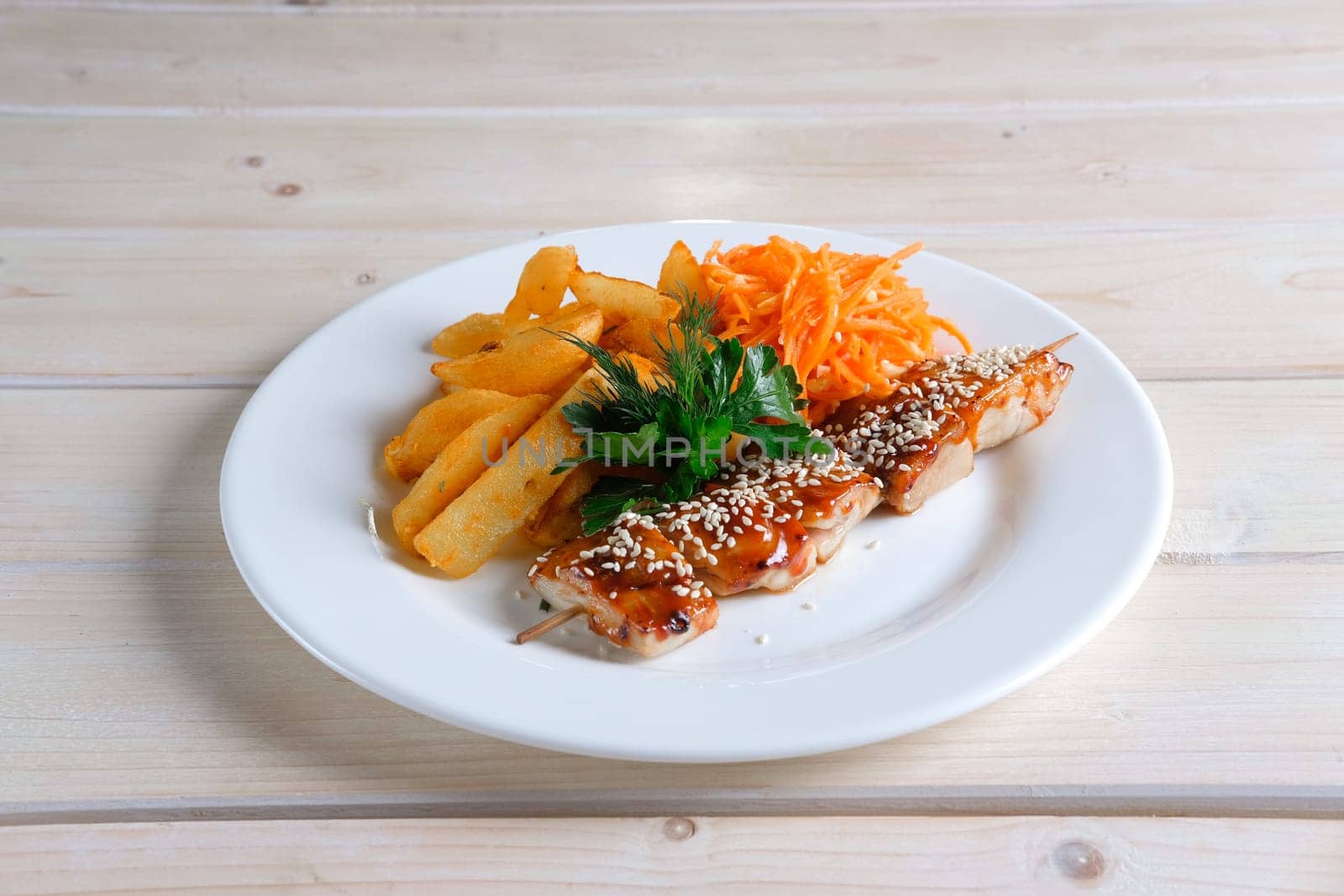 Chicken shashlik with fried potato and spicy carrit