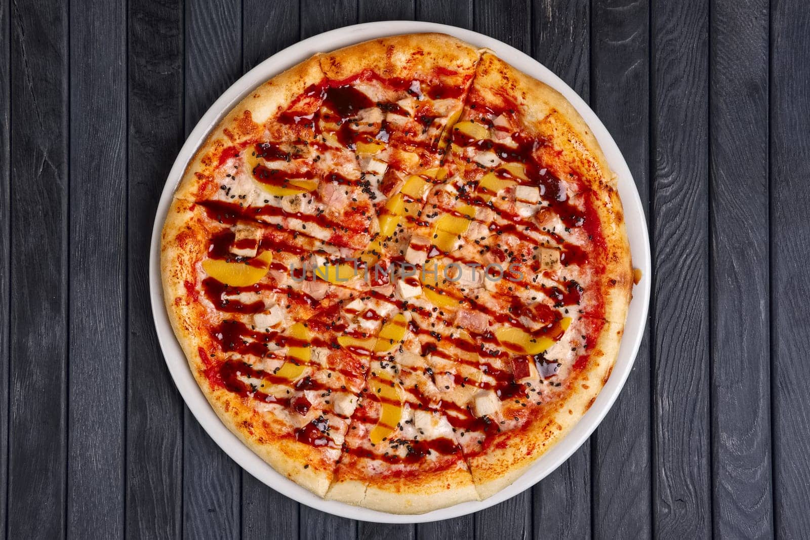 Top view of pizza with chicken, plum and barbecue sauce