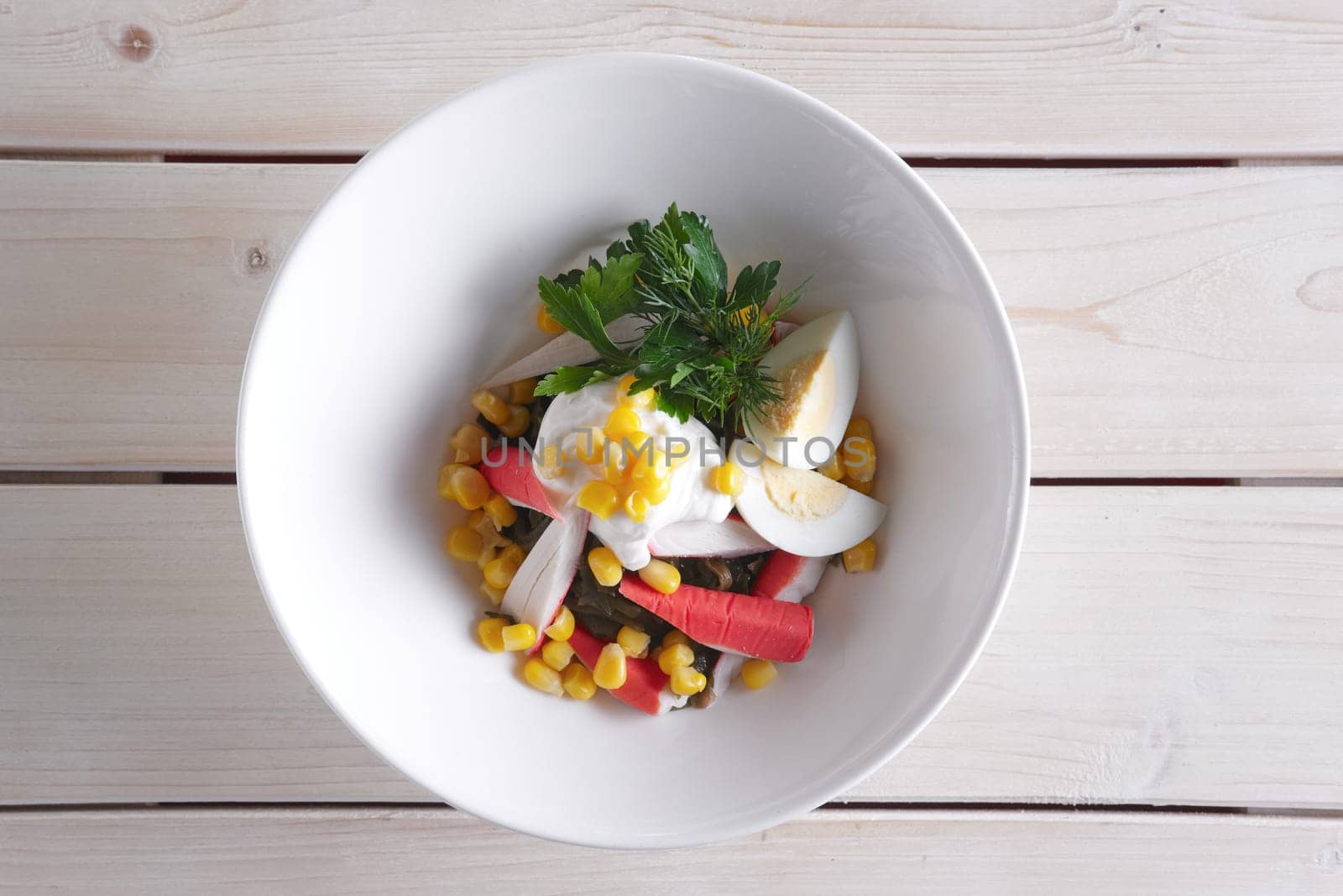 Salad with sea kale, crab meat, egg, corn and mayonnaise