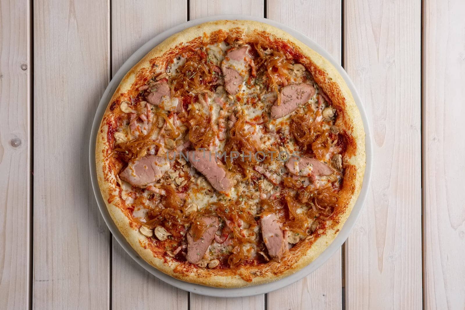 Freshly baked pizza with beef and fried onion