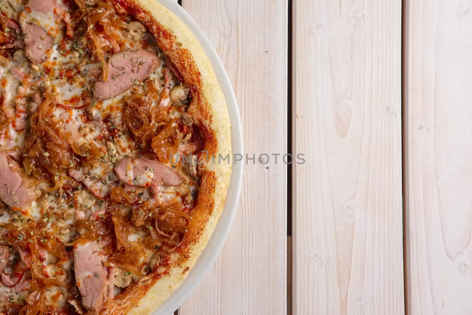 Freshly baked pizza with beef and fried onion