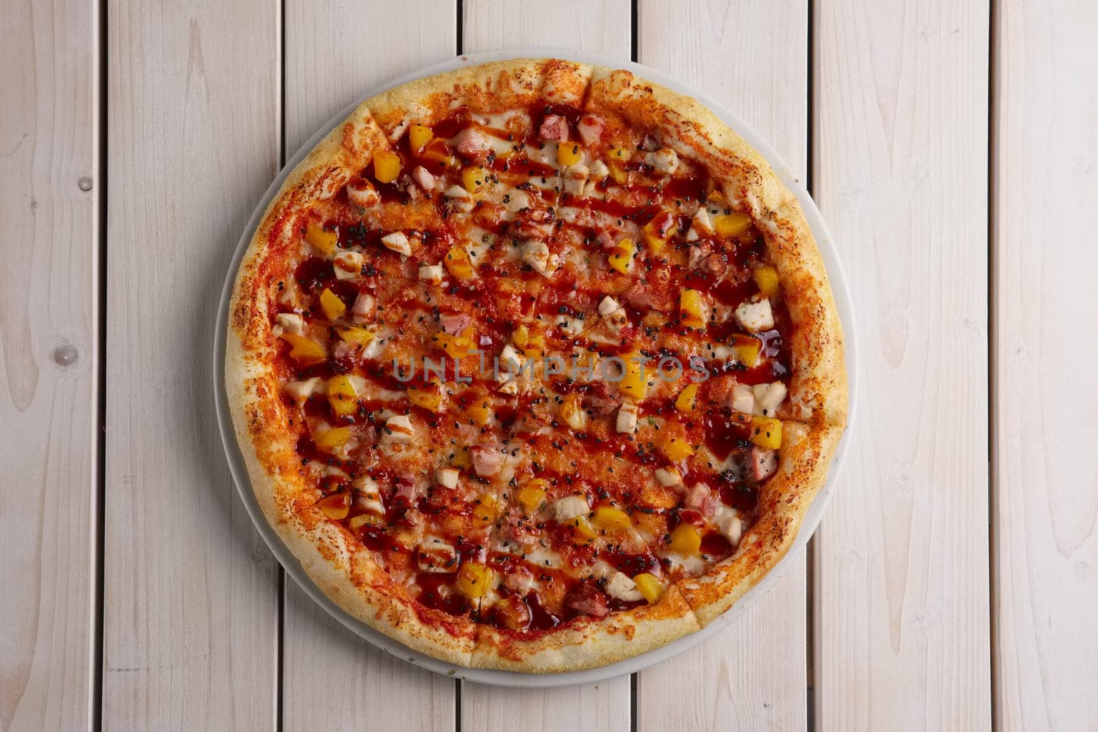 Pizza with chicken, pineapple, cheese and barbecue sauce