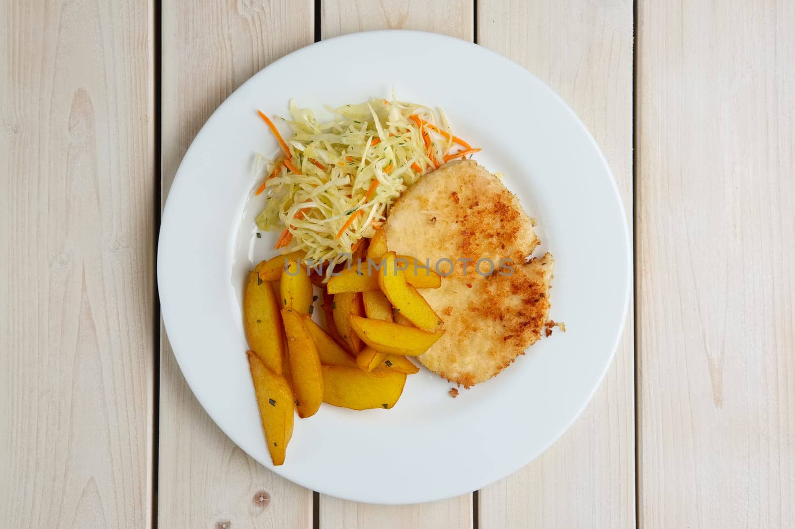 Chop cutlet with fried potato and fresh cabbage and carrot