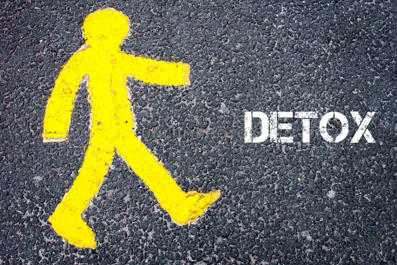 Yellow pedestrian figure on the road walking towards DETOX. Conceptual image with Text message over asphalt background.