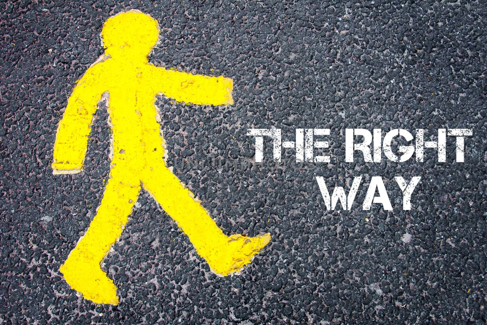 Yellow pedestrian figure on the road walking towards THE RIGHT WAY. Conceptual image with Text message over asphalt background.