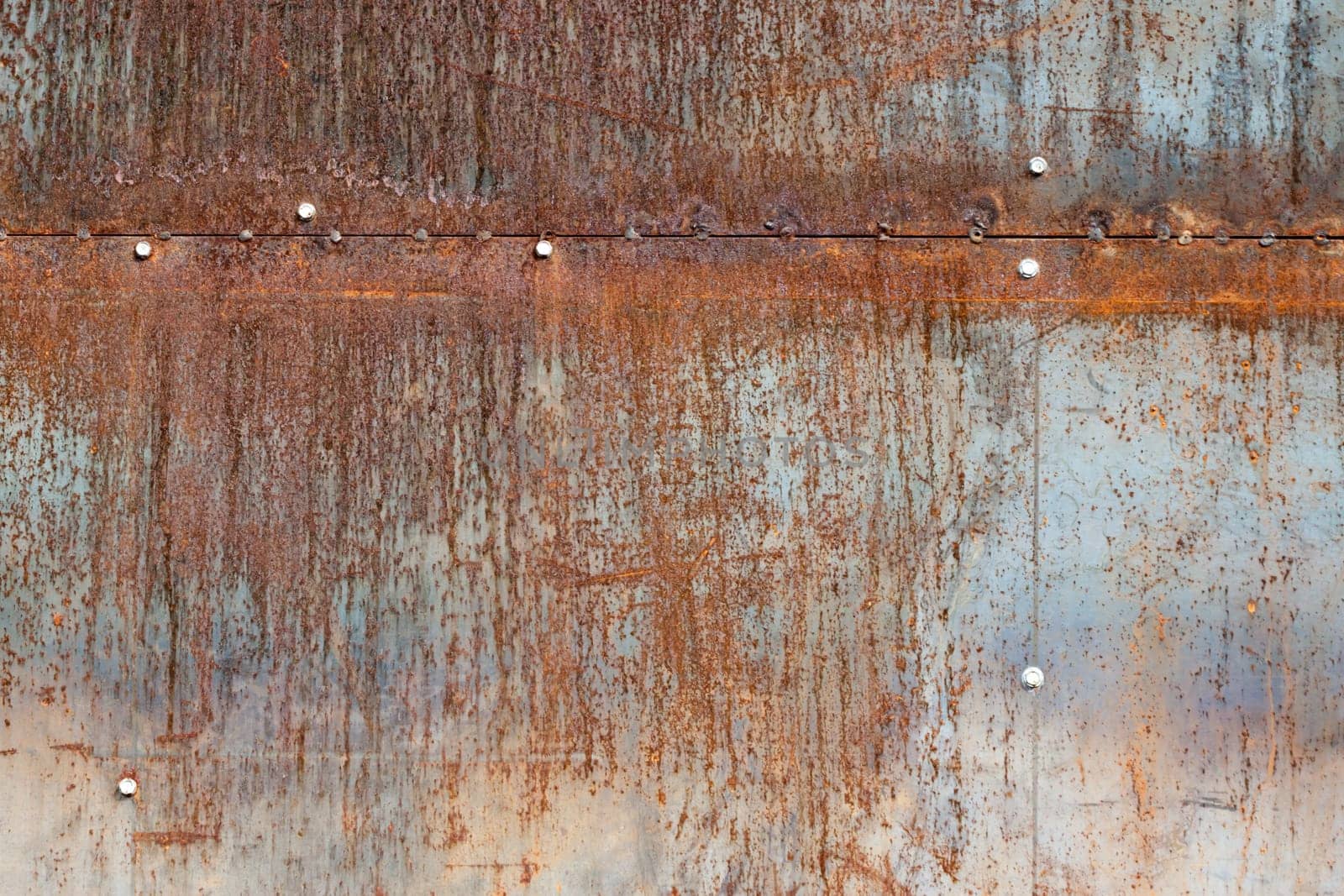 scratched and rusty orange metal surface as background