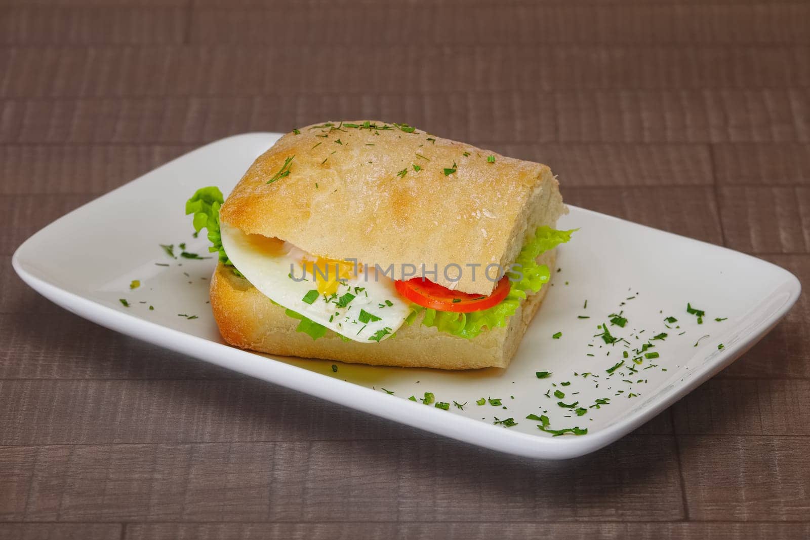 Ciabatta panini sandwich with chicken and tomato. Sandwich stuffed with sausage, egg and tomato.