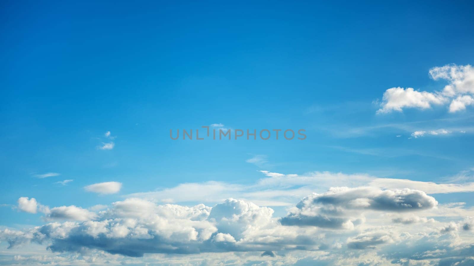 Landscape of a beautiful blue sky covered with cumulonimbus clouds on a summer afternoon. Unspoiled nature.