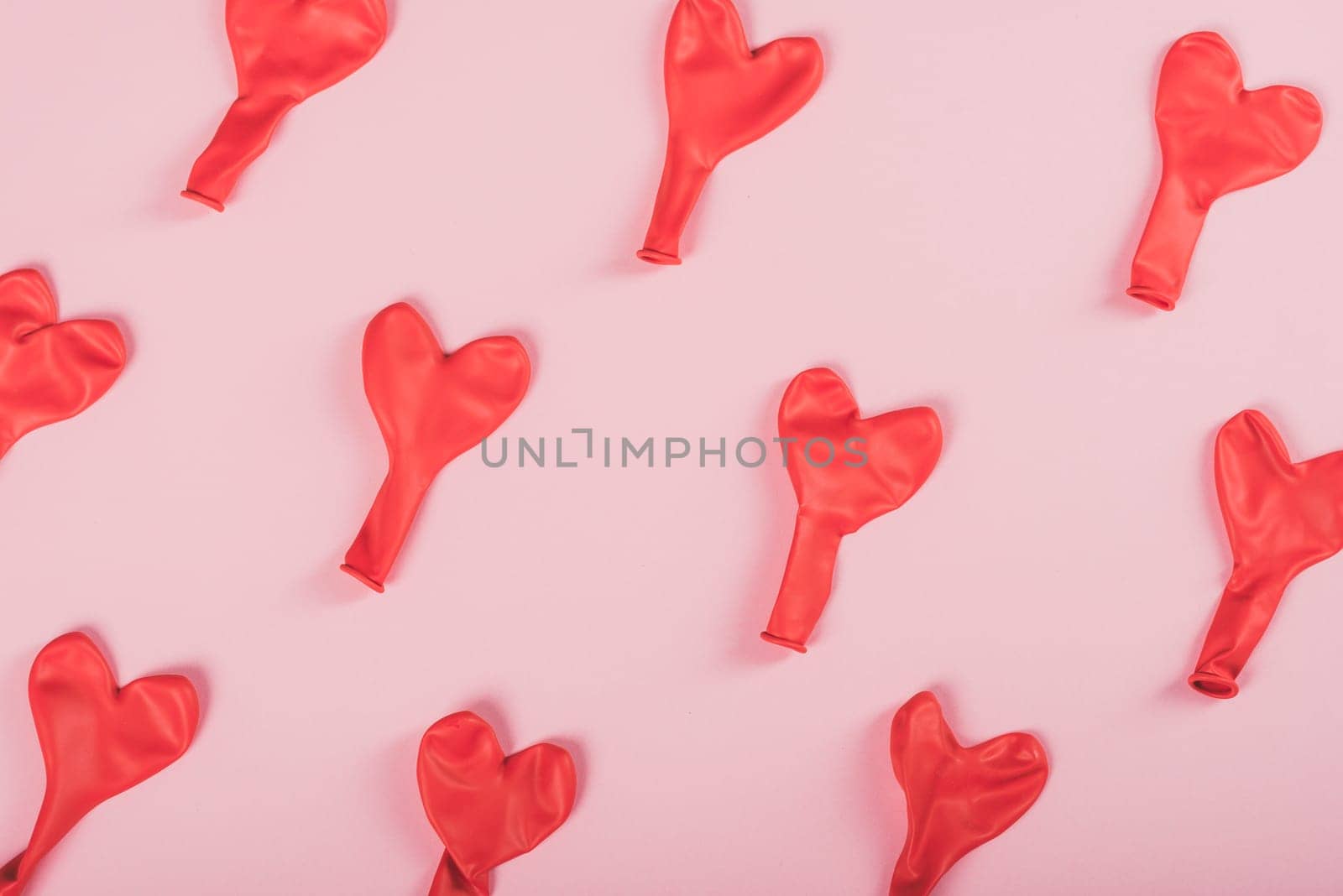 Red valentine hearts pattern on pink background. Valentine's day design. Flat lay.