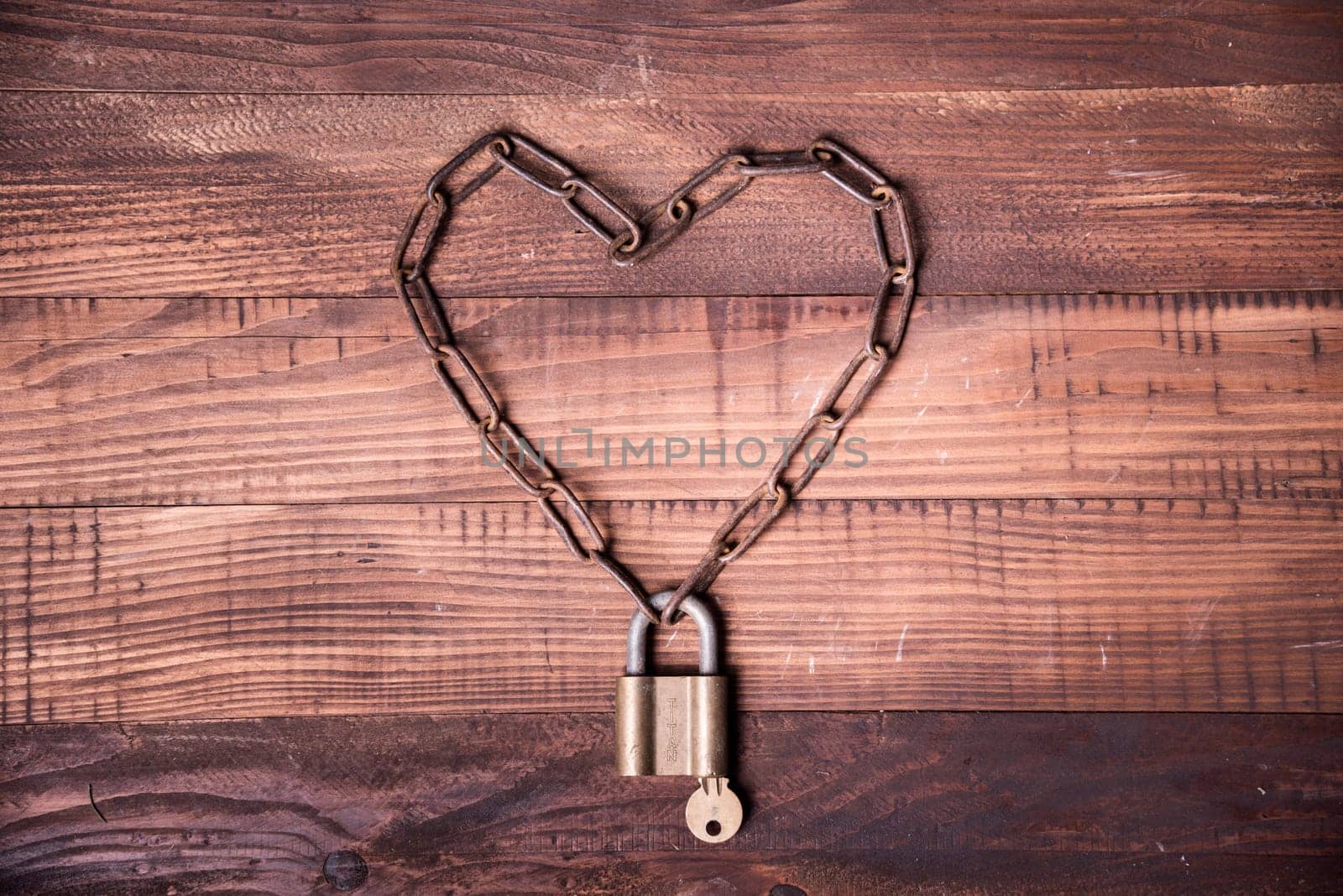 Valentine's day background design. Top view of valentine heart with locked chain and key.