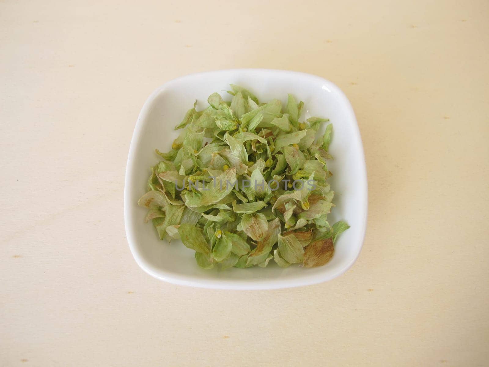Dried hop flowers on a wooden board