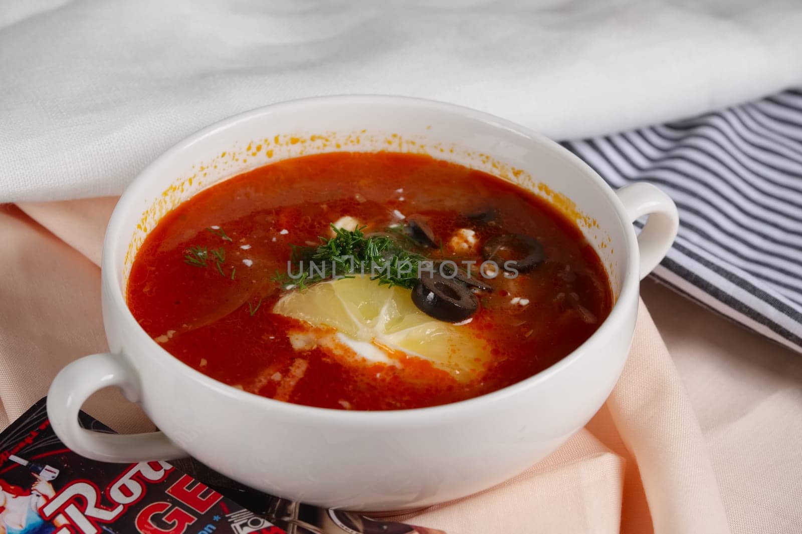 Russian traditional solyanka soup. Authentic soup saltwort in ceramic plate.