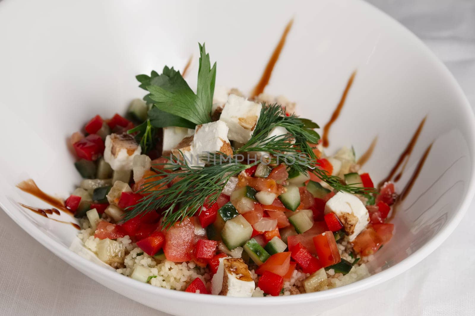 Plate of salad with feta, pepper, tomato and cucumber