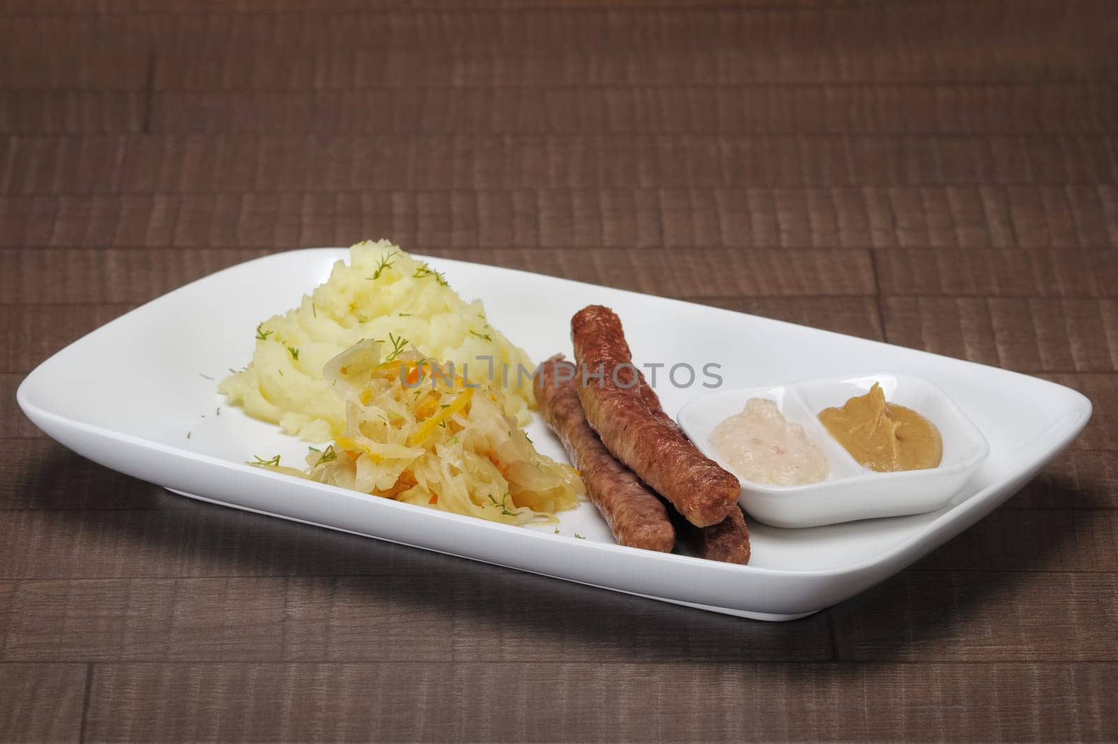 Homemade sausage with mashed potato and sauerkraut.