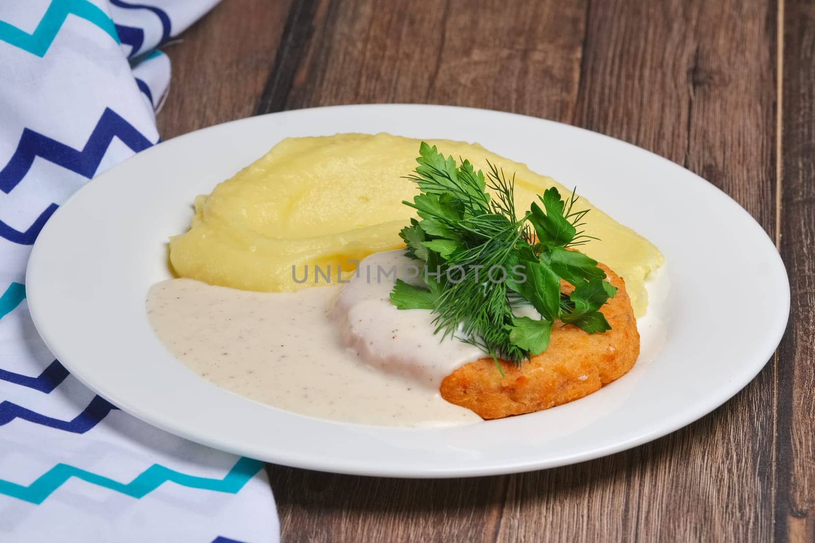 Salmon cutlet and mashed potato with creamy sauce