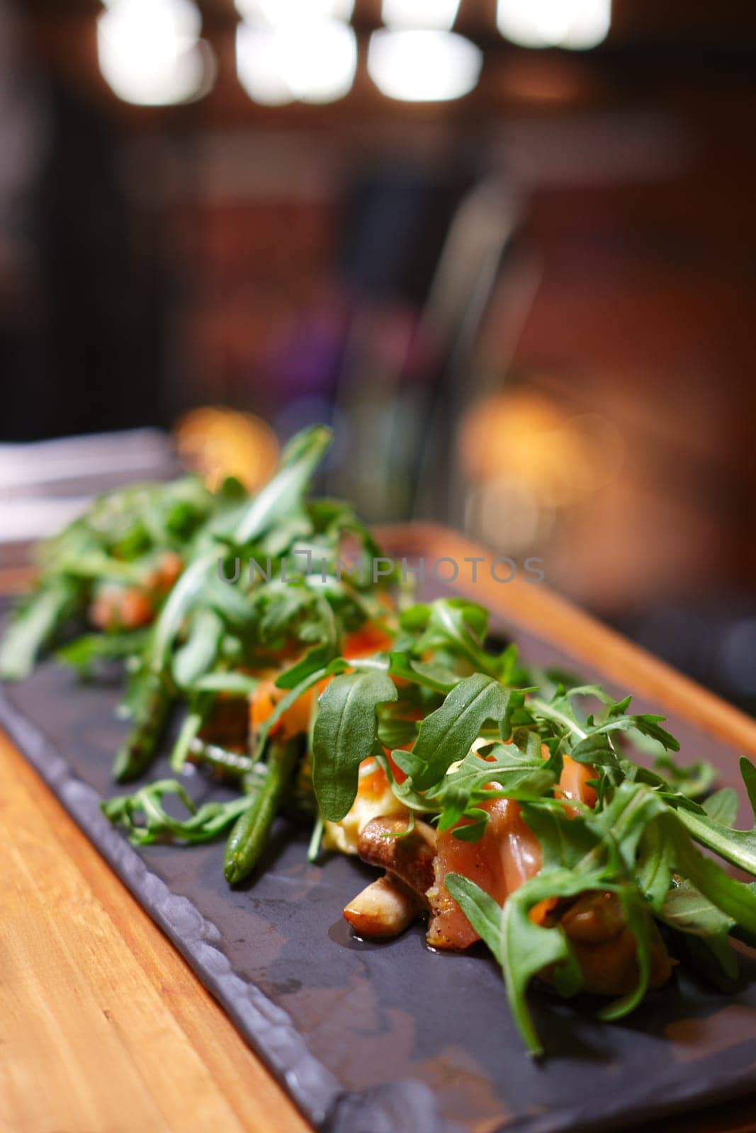 Smoked salmon with mushroom and bean decorated with ruccola. Photo taken with shallow depth of field.