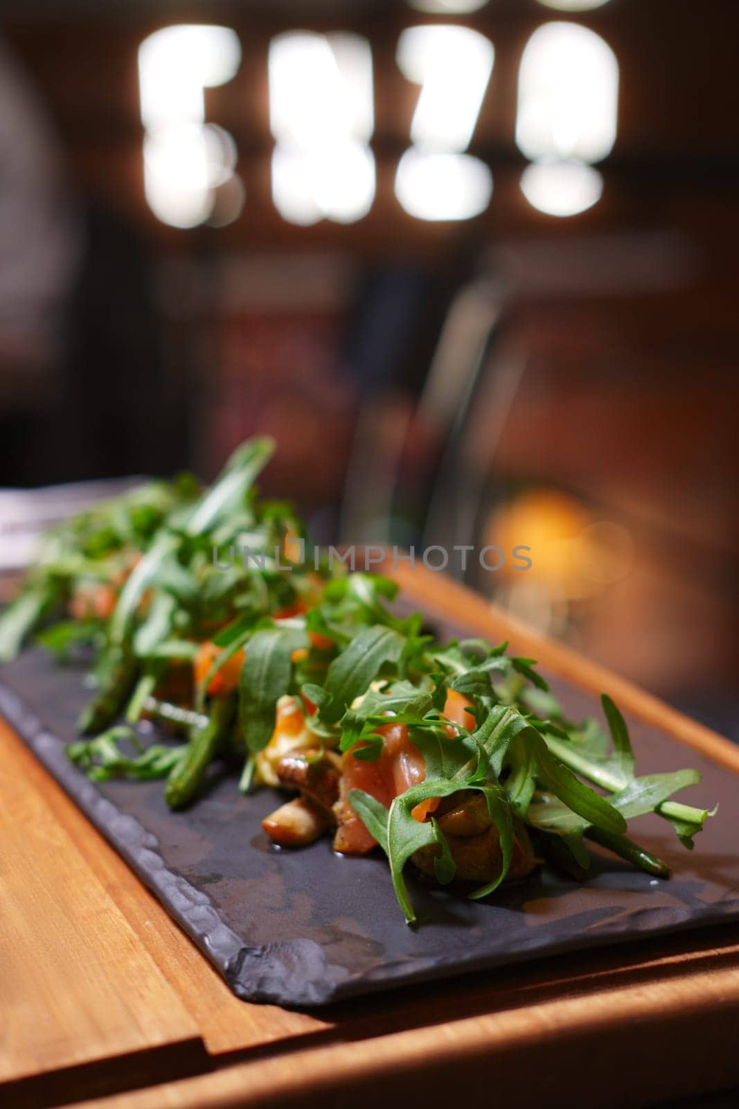 Smoked salmon with mushroom and bean decorated with ruccola. Photo taken with shallow depth of field.