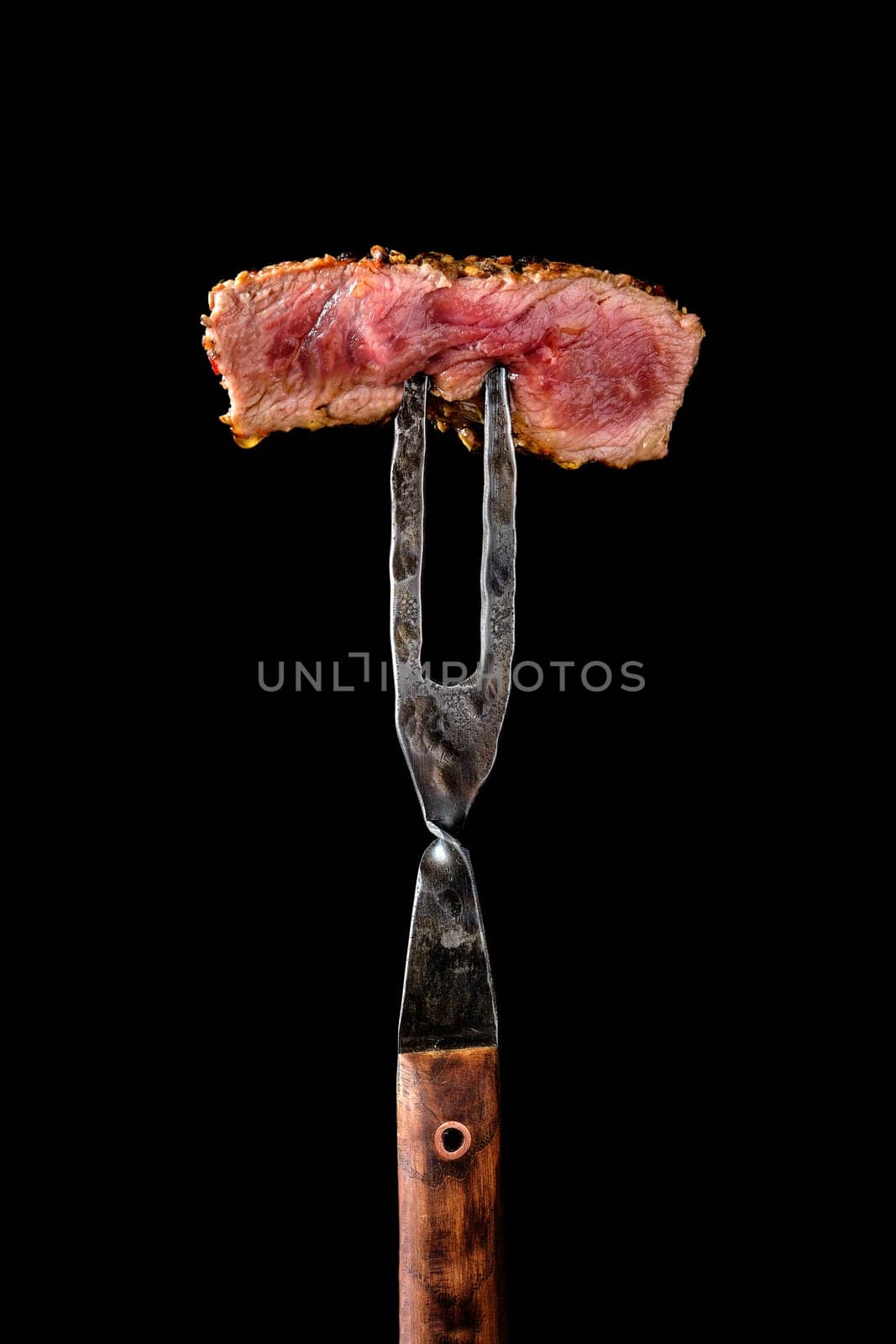 Piece of medium rare steak on the fork