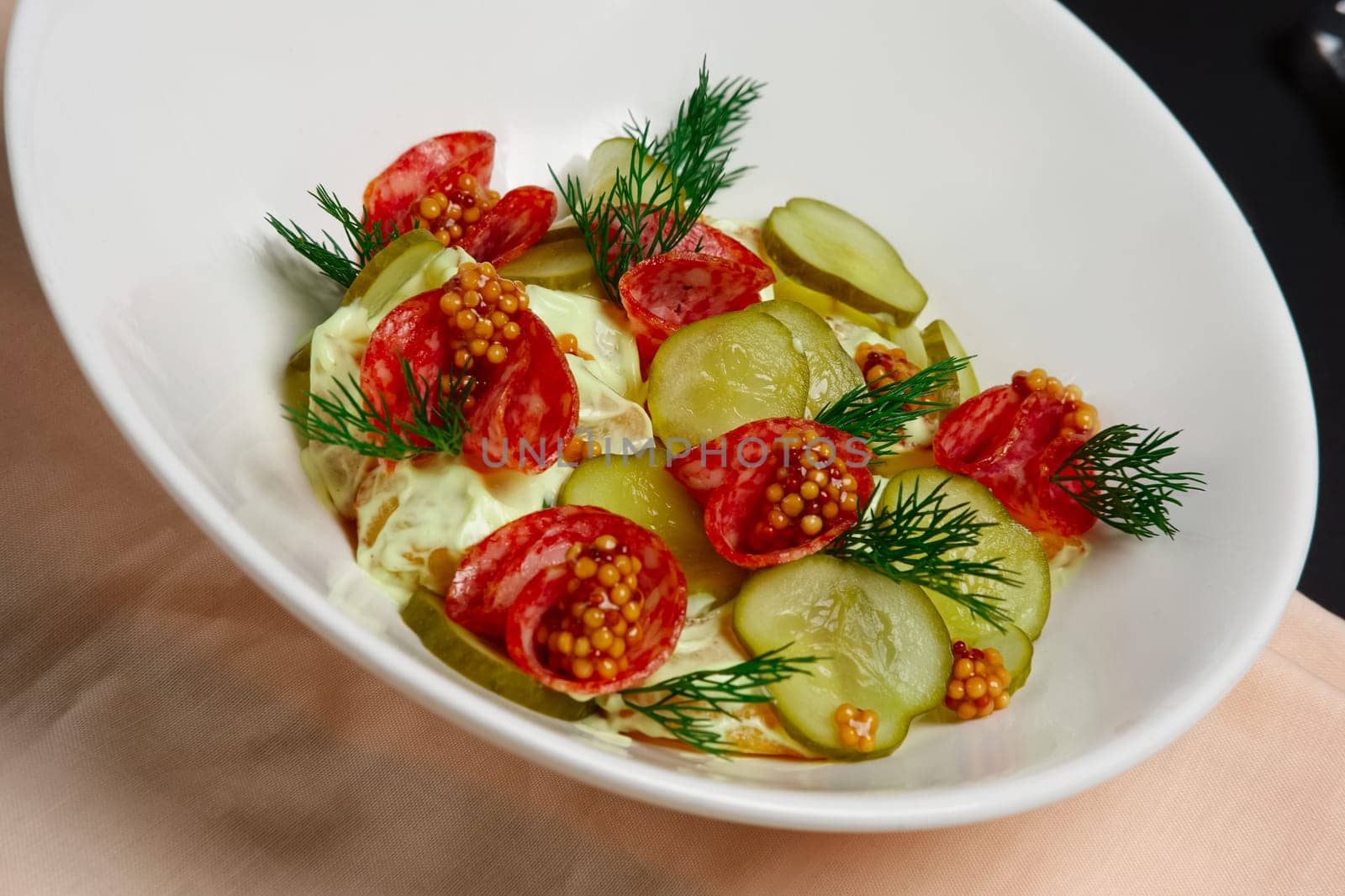 Plate with cucumber and cabbage salad with sausage and whole grain french mustard