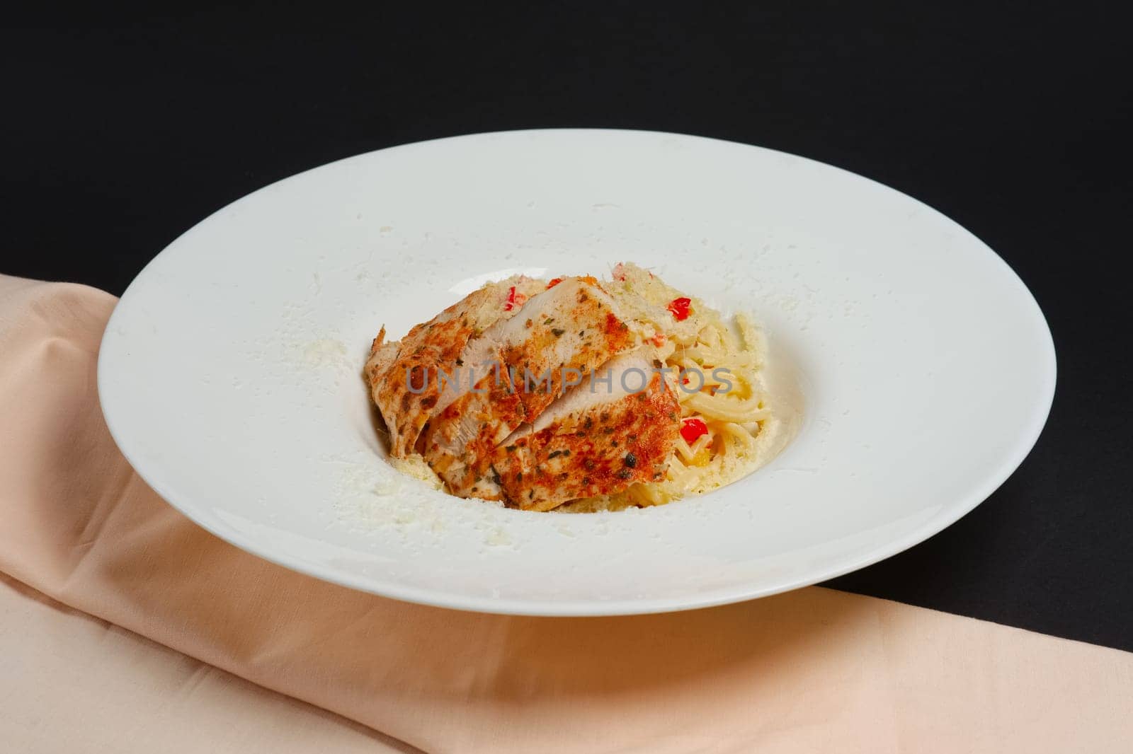 plate with pasta, cheese and chicken fillet