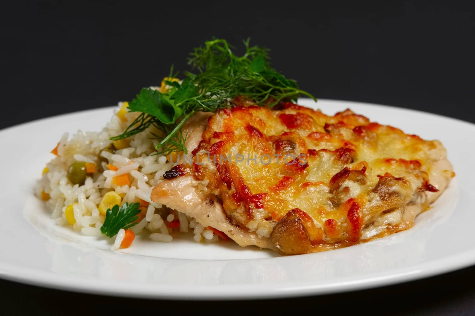 Baked meat with mushrooms and cheese with rice and sweet corn