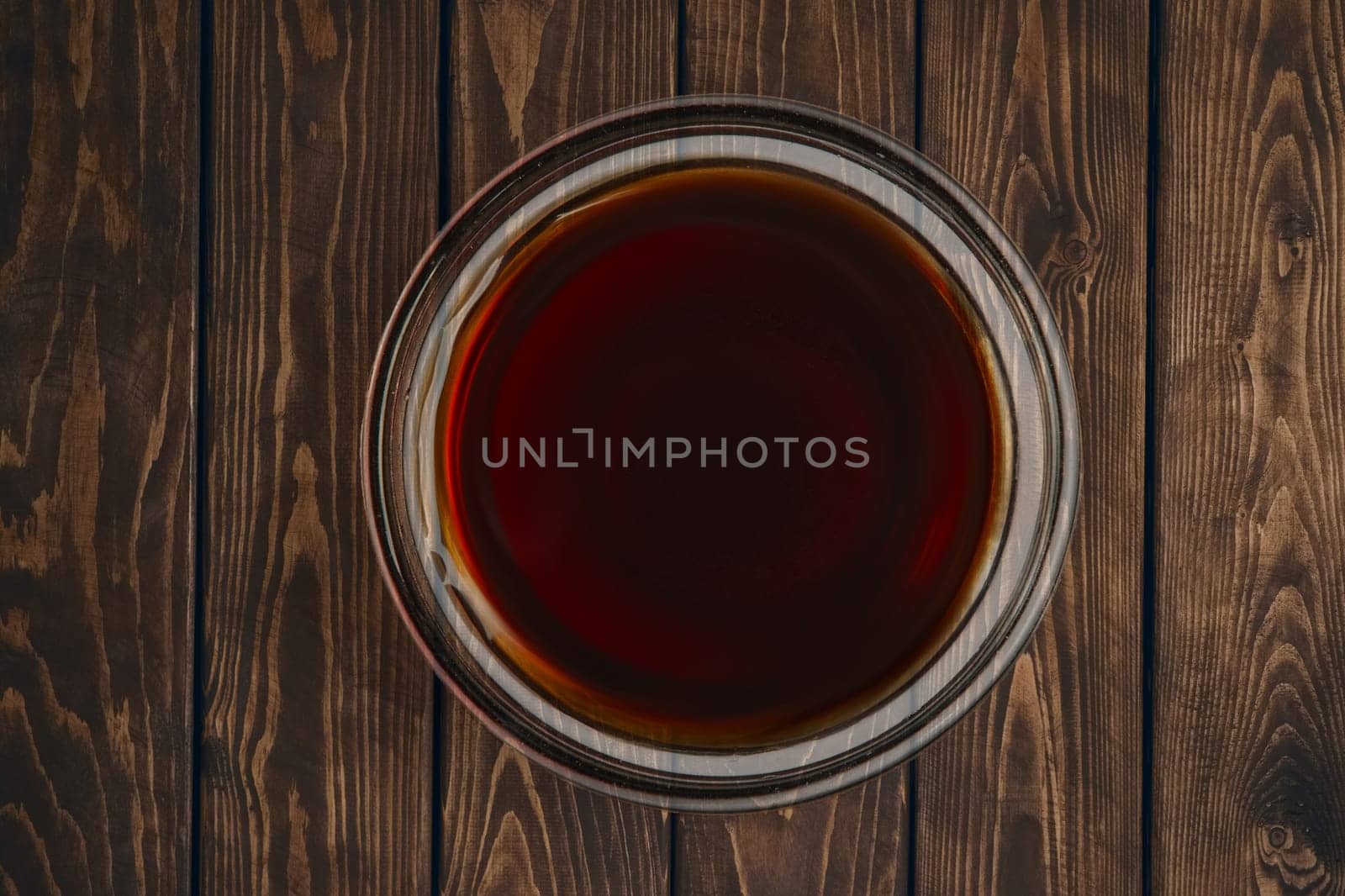 Top view of plate with soy sauce on wooden table